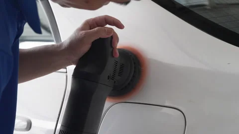 Close up hands of a man using an electric car wax polisher to wax the car Stock Footage 246115856