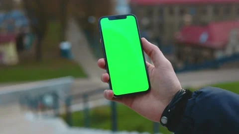 Close up hands man using phone with vertical green screen background street city Stock Footage 145845832