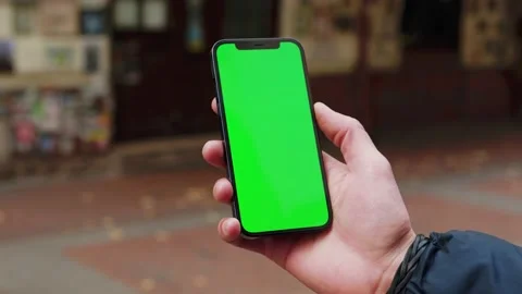 Close up hands man using phone with vertical green screen background on street Stock Footage 145848288