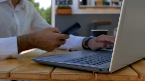 Close-up hands of a man in a white shirt who are typing on a laptop keyboard. Stock Footage 113965827