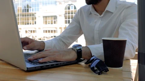 Close up hands of a man in a white shirt who are typing on a laptop keyboard Stock Footage 113965862