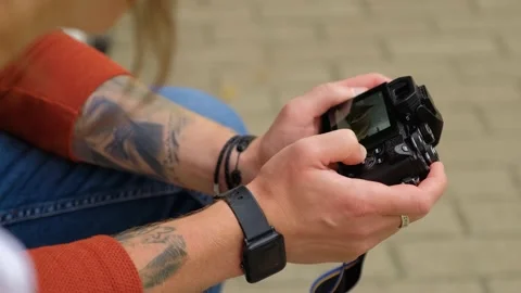 Close-up of hands of a man who is leafing through photos on the camera screen Video stock 139111294