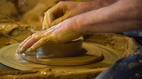 Close-up of the hands of a man who makes a clay jug on a Potter's wheel. Stock Footage 123852735
