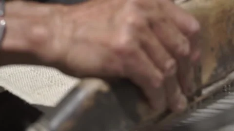 Close-up hands manipulating fabrics on old antique traditional wooden loom Stock-Footage 294019990