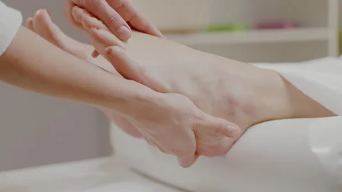 Close up hands masseuse doing wellness foot massage woman client in spa room. Stock Footage 197658627