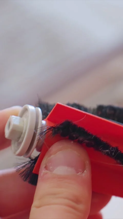 Close up of hands meticulously cleaning synthetic eyelashes with small brush to Stock Footage 346790280
