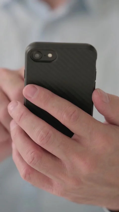 Close up of Hands of Middle Aged Man Using Smartphone, Vertical Video 스톡 동영상 339584332