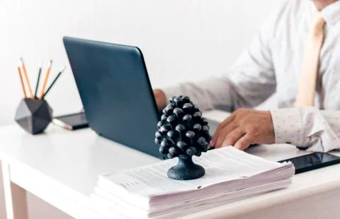 Close-up of hands middle-aged man in white shirt and yellow tie typing on key Stock Photos