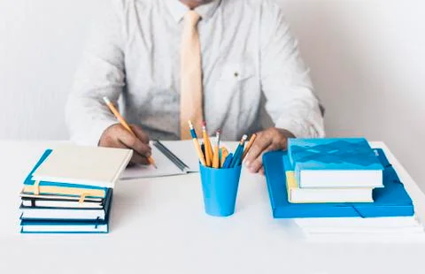 Close-up of hands middle-aged man in white shirt typing on keyboard laptop co Stock Photos