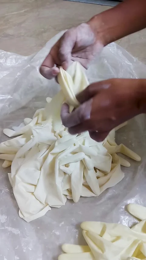 Close-up of hands mixing cornstarch powder on disposable medical gloves. Stock Footage 327375307