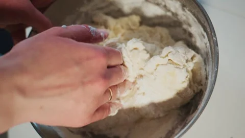 Close-up of hands mixing dough Stock Footage 336047060