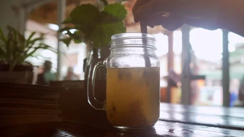 Close up Hands Mixing Passion Fruit Cocktail Lemonade with Eco-Friendly Straw. Stock Footage 108622997