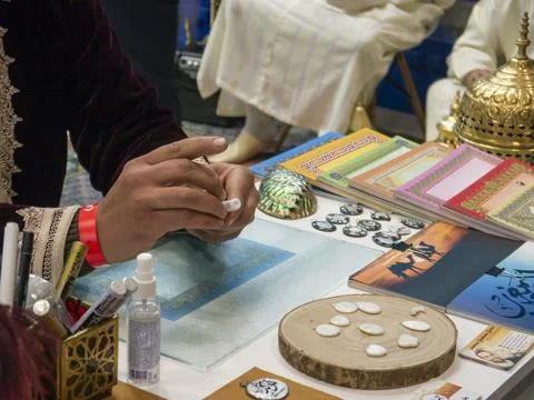 Close up of the hands of a Moroccan artisan preparing material for handicra.. Stock Photos