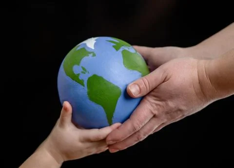 Close up hands of mother gives the planet into the hands of a child. Isolated Stock Photos