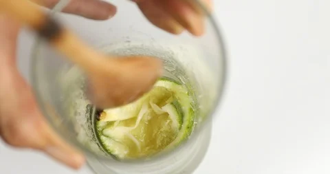 Close up of hands muddling to make Mojito Cocktail Stock Footage 107969897