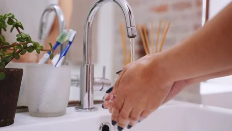 Close up of hands, multicultural female washing her hands thoroughly under tap Stock Footage 166940407