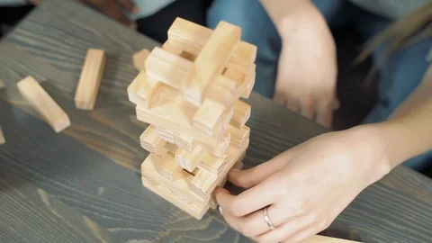 Close up hands of multinational friends playing block removal game. Stock Footage 122731158