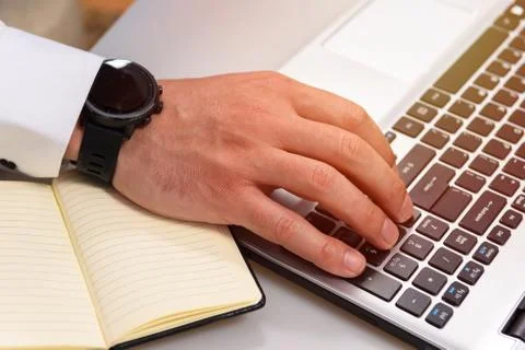 Close up hands multitasking man using laptop Stock Photos