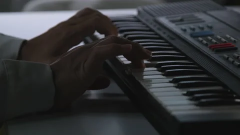 Close-up hands of Musician practicing keyboard playing in a studio. Piano keys 動画素材 176897129