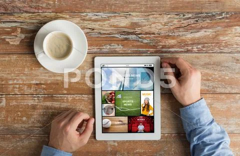 Close up of hands with news page on tablet pc Stock Photos