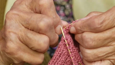 Close-up of a hands of old grandma knitting warm traditional Serbian socks Stock Footage