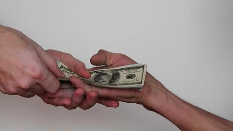 Close-up in the hands of an old man, a man puts a stack of cash 100 dollars.. Stock Footage 237361707