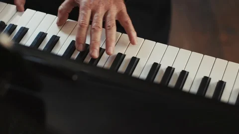 Close up hands old man pianist playing the fortepiano in a deserted restaurant Stock Footage 98246741