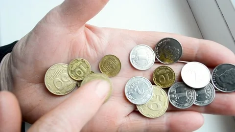 Close-up hands of old women counting Ukrainian  coins kopiikas,  deficiency of m Stock Footage 182967077
