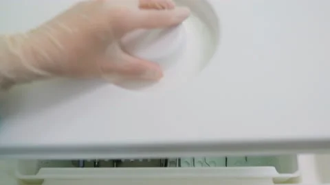 Close up of hands open the box with medical instruments in sterilizing liquid Stock Footage 131483797