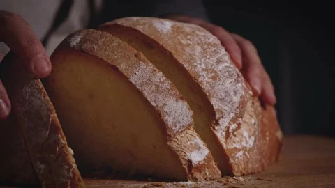 Close up of hands that open a traditional bread. Healthy, natural food for meal  動画素材 147938686