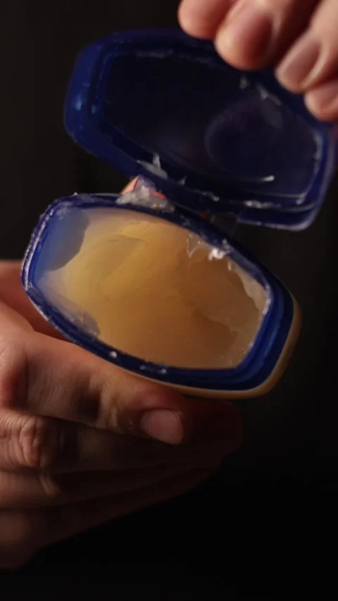 Close-up of hands opening and closing a petroleum jelly jar Video stock 343838050