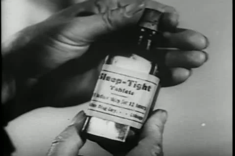 Close-up of hands opening bottle of sleeping pills Stock Footage 11352375