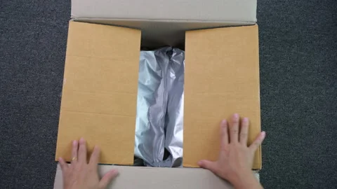 Close-up of hands opening a cardboard box with a product. Stock Footage 220440591