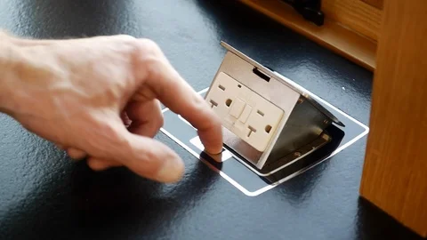 Close-up of hands opening electrical plug in kitchen countertop. Stock Footage 98013962