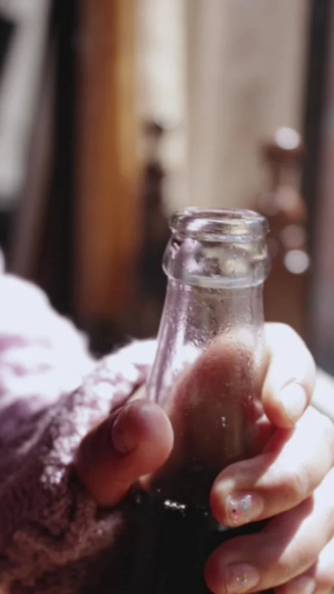 Close-up of hands opening a glass bottle of soda Stock Footage 314912804
