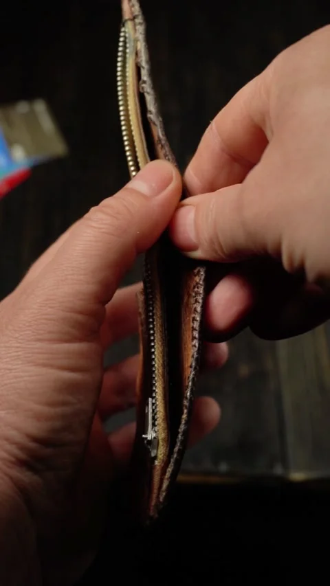 Close-up of hands opening a leather wallet, revealing its interior compartments Stock Footage 332068148