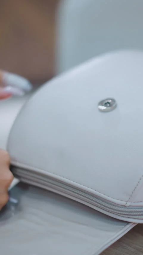 Close-Up of Hands Opening Stylish White Bag on Table Stock Footage 310705996