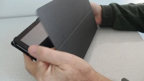 Close-Up of Hands Opening Tablet Case and Turning On Device. Stock Footage 345639956