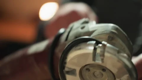 Close up of hands operating angle grinder on mechanical tool detail shot in Vídeo Stock 347102395