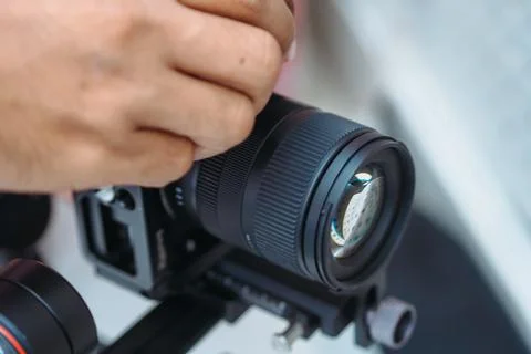 Close up of hands operating the camera, close up focused on the lens Stock Photos