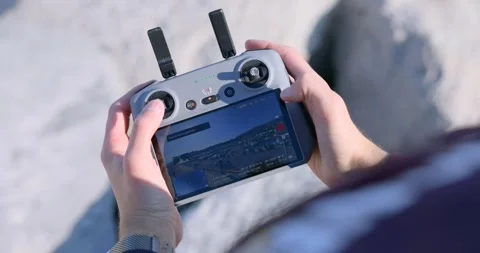 Close-up of hands operating a drone controller with built-in screen outdoors Stock Footage 343927969