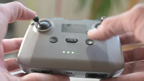 Close-up of hands operating a drone remote controller, pressing buttons and Stock Footage 319495460