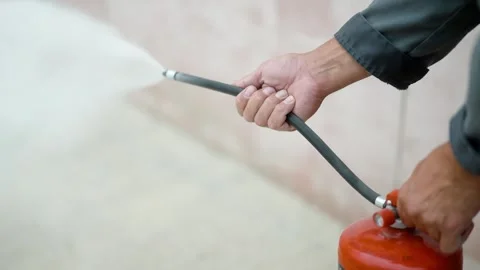 Close-up of hands operating a fire extinguisher during the accident. Stock Footage 272756025