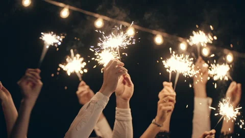 Close-up of hands or palms holding and waving burning sparklers in front of Stock Footage 172081210