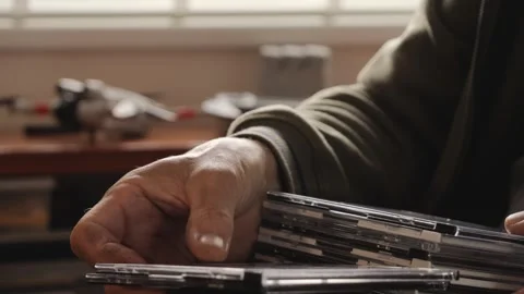 Close-up of hands organizing CD cases Stock Footage 312166772