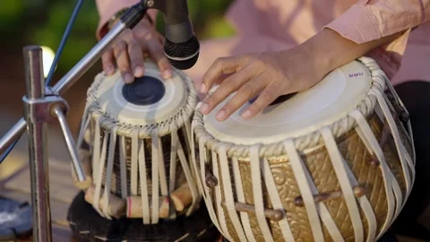 Close-up of hands of an pakistani man playing a paired tabla drum. A pair of Stock Footage 337739306