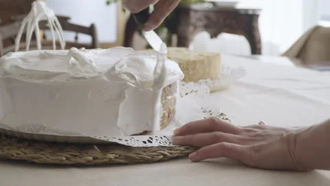 Close up of the hands of a pastry chef delicately finishing a cake Stock-Footage 240052757