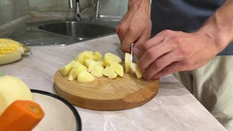 Close up of hands peeling and chopping potatoes 스톡 동영상 281337704