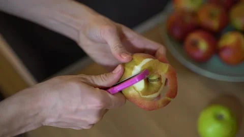 Close-up of hands peeling an apple. Woman's hands removes the skin of apple Stock Footage 235735929