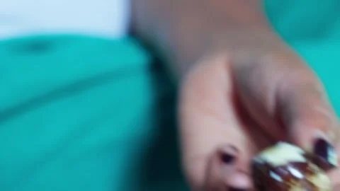 Close Up of Hands Peeling a Boiled Quail Egg with Brown Speckled Shell Stock Footage 327834696